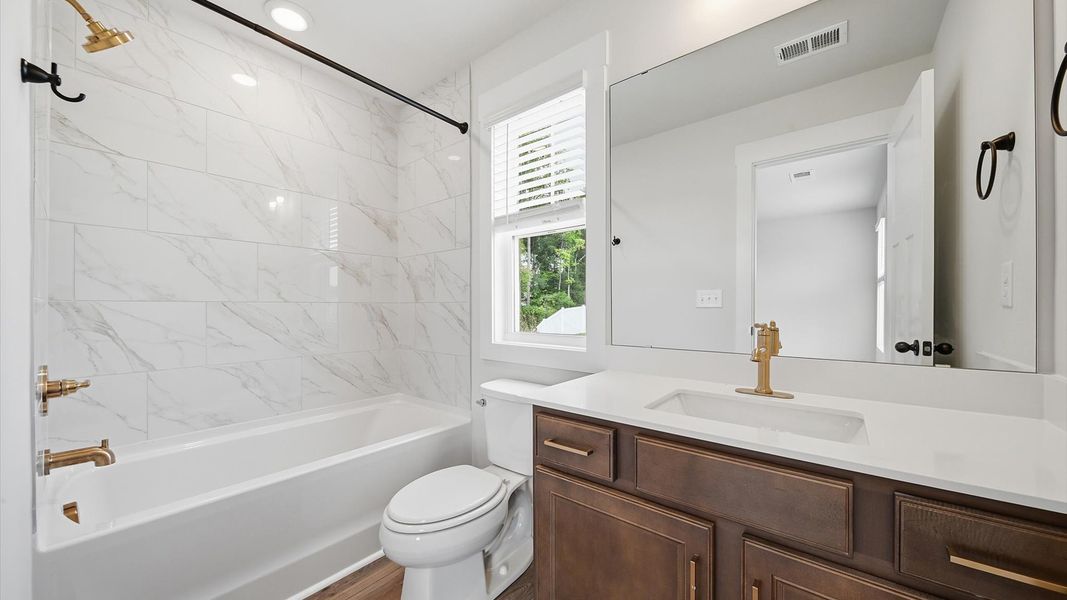 Accomplished bathroom design with sleek tile, high-quality cabinetry, and refined hardware