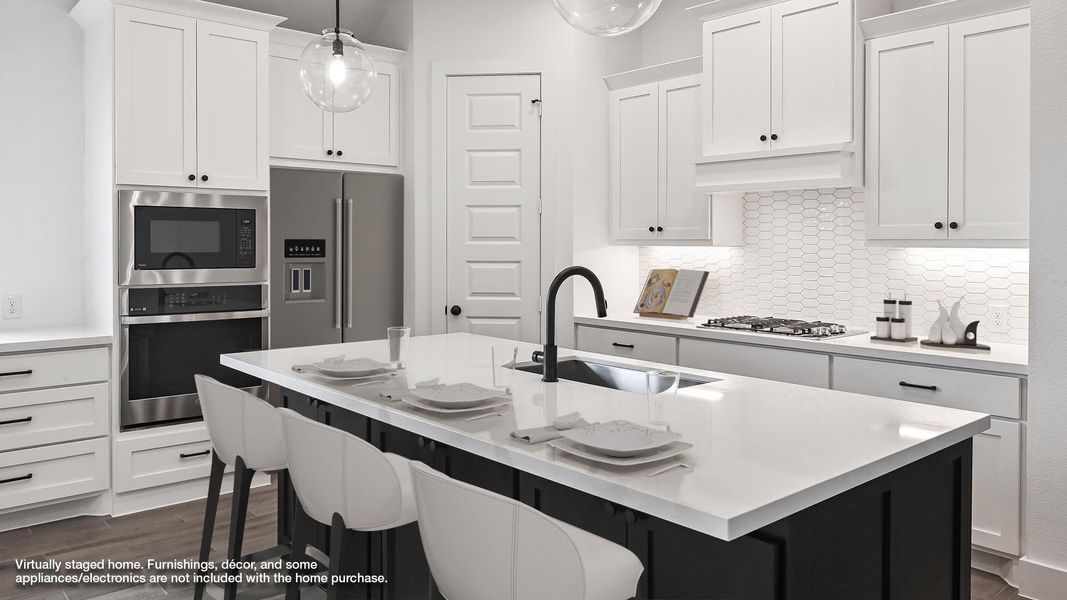Kitchen with stainless steel appliances, a sink, white cabinets, and a kitchen breakfast bar Kitchen with stainless steel appliances, a sink, white cabinets, and a kitchen breakfast bar