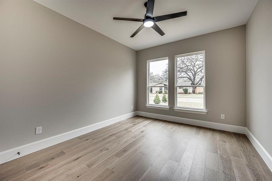 Unfurnished room featuring ceiling fan and light hardwood / wood-style floors