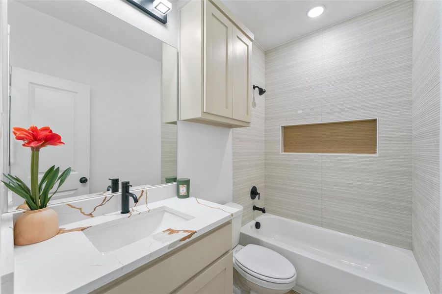 Contemporary bathroom featuring a white rectangular undermount sink, a white countertop with brown veining, and a matte black single-handle faucet Contemporary bathroom featuring a white rectangular undermount sink, a white countertop with brown veining, and a matte black single-handle faucet
