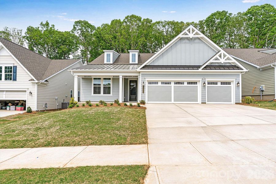 Front exterior of a new home in Cresswind Charlotte, Mint Hill, NC, highlighting curb appeal (Image 20). Front exterior of a new home in Cresswind Charlotte, Mint Hill, NC, highlighting curb appeal (Image 20).