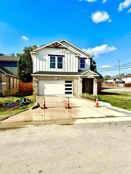 View of front facade with a front lawn and a garage