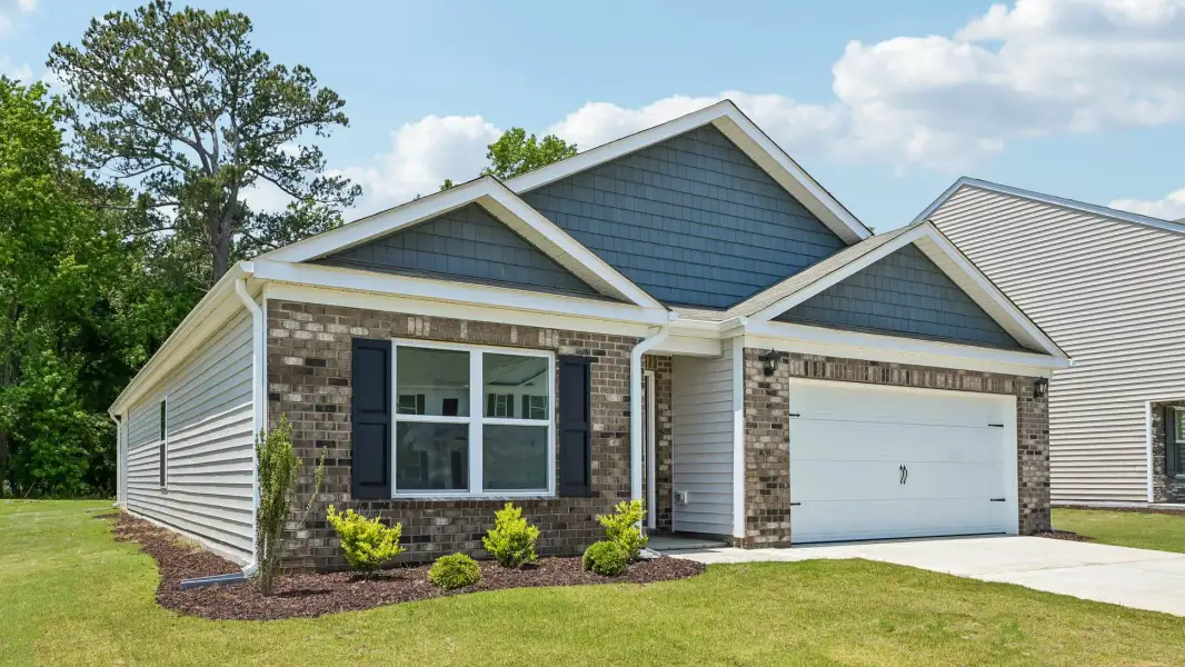 Front exterior of a new home in Mangum Farms, Stem, NC, highlighting curb appeal (Image 19).