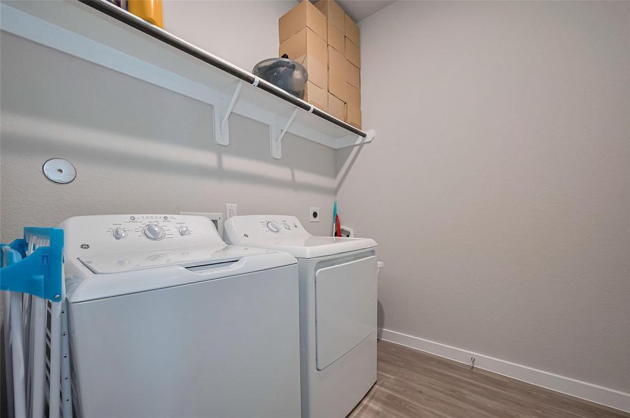 Laundry room with washer/dryer setup.