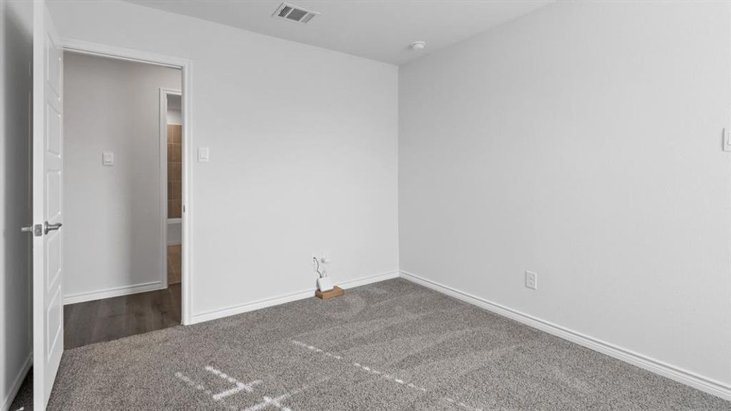 Carpeted empty room with baseboards