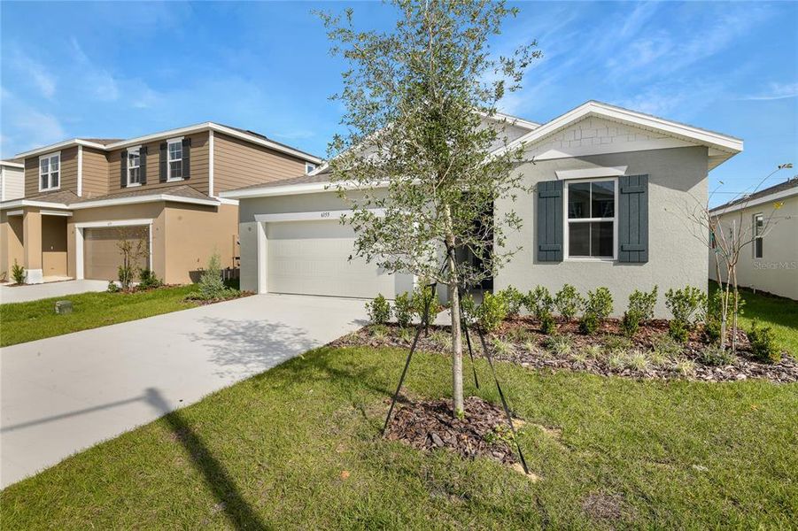 Front exterior of a new home in Seasons at Scenic Terrace, Lake Hamilton, FL, highlighting curb appeal (Image 1). Front exterior of a new home in Seasons at Scenic Terrace, Lake Hamilton, FL, highlighting curb appeal (Image 1).