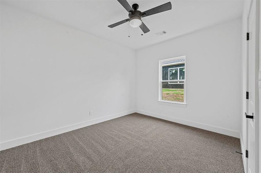 Spare room with carpet and ceiling fan