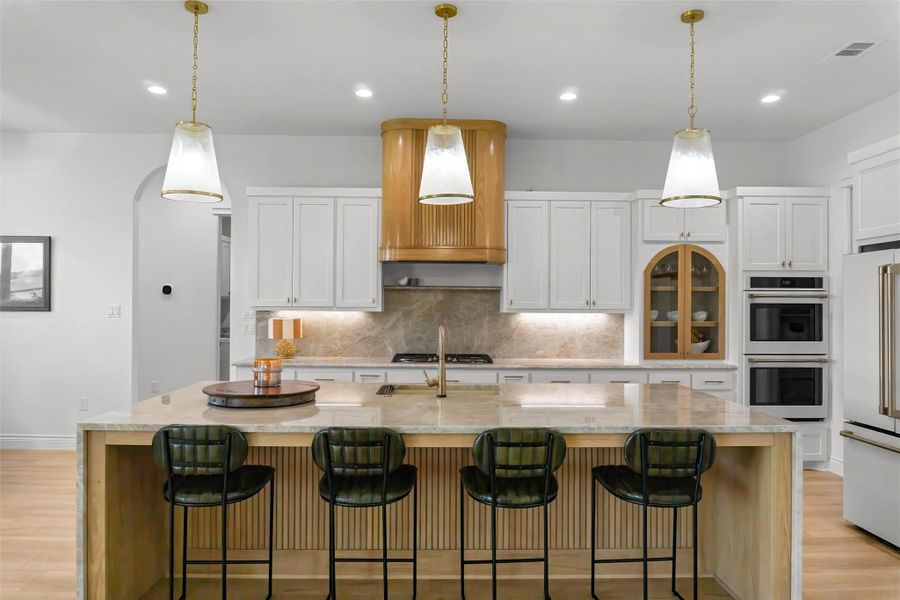 Large kitchen Island with custom finishes and lighting. Large kitchen Island with custom finishes and lighting.