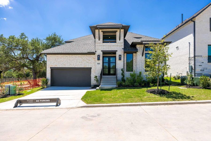 Front exterior of a new home in Wolf Ranch, Georgetown, TX, highlighting curb appeal (Image 2). Front exterior of a new home in Wolf Ranch, Georgetown, TX, highlighting curb appeal (Image 2).