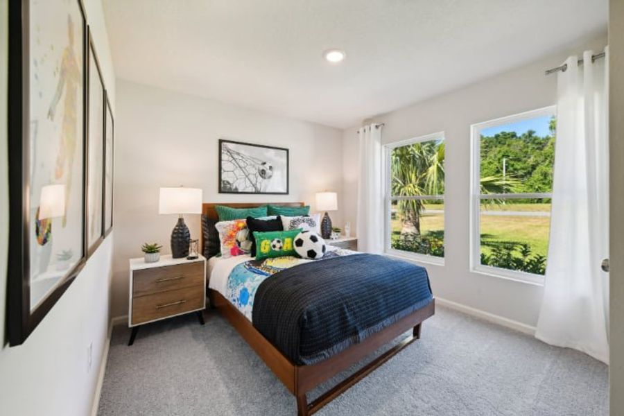 A bedroom with a bed and a window. A bedroom with a bed and a window.