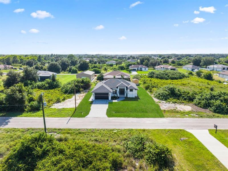 Front exterior of a new home in , Lehigh Acres, FL, highlighting curb appeal (Image 26). Front exterior of a new home in , Lehigh Acres, FL, highlighting curb appeal (Image 26).