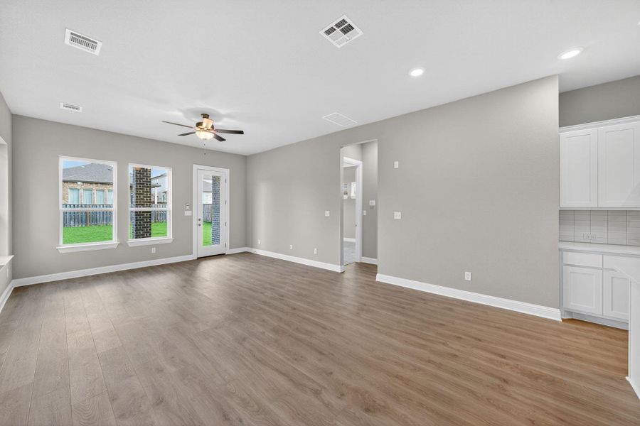 Unfurnished living room with light wood-style floors, ceiling fan, and recessed lighting Unfurnished living room with light wood-style floors, ceiling fan, and recessed lighting