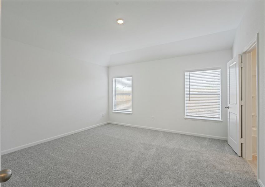 Large master bedroom with two windows for plenty of natural light