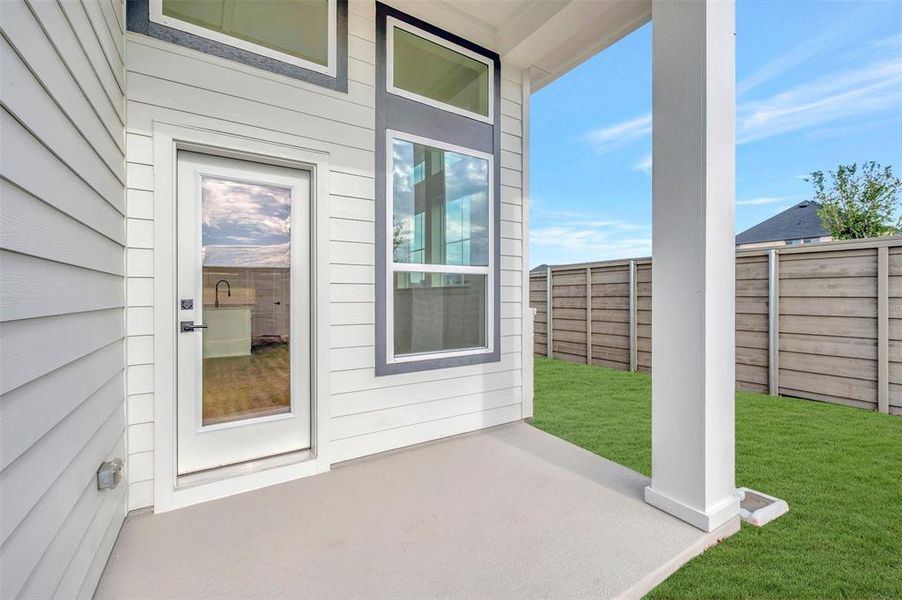 Covered patio featuring a concrete slab and a white support column
