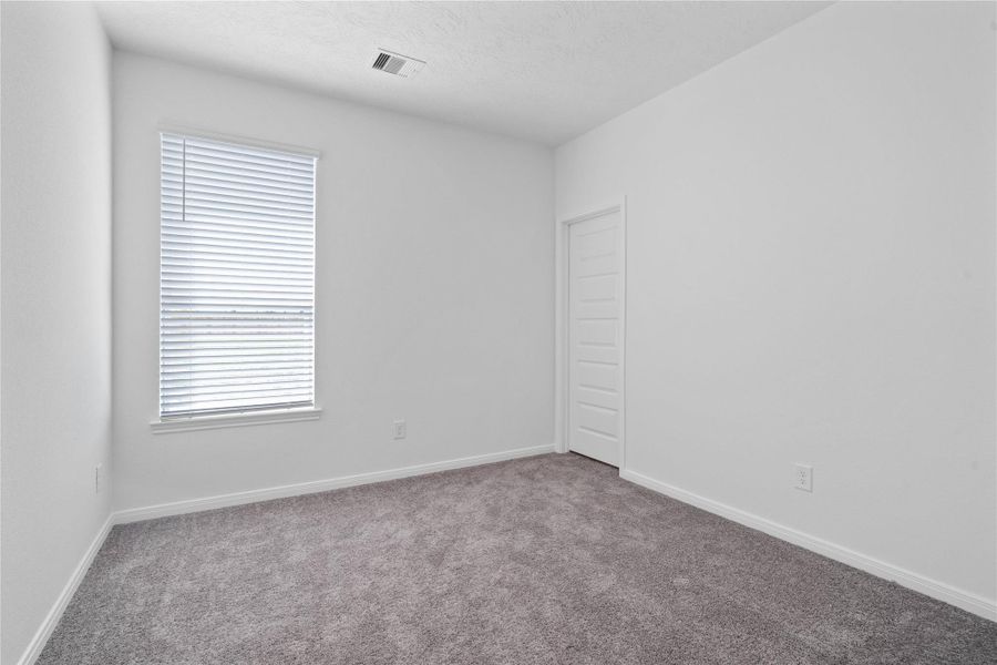 The spacious Den offers cozy carpet flooring, a large window, and an ample sized closet. This versatile den significantly expands the home’s footprint, providing valuable added living space.