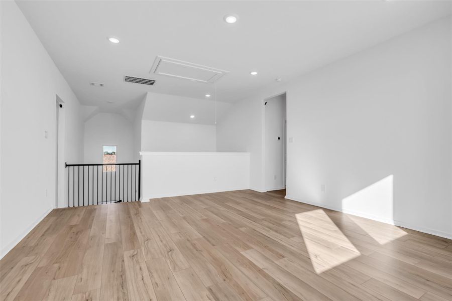 Game Room / Flex Space: Alternate view highlighting the expansive footprint, stair railing, and direct access to bedrooms and the media room, underscoring the scale and openness of this upper level. Game Room / Flex Space: Alternate view highlighting the expansive footprint, stair railing, and direct access to bedrooms and the media room, underscoring the scale and openness of this upper level.