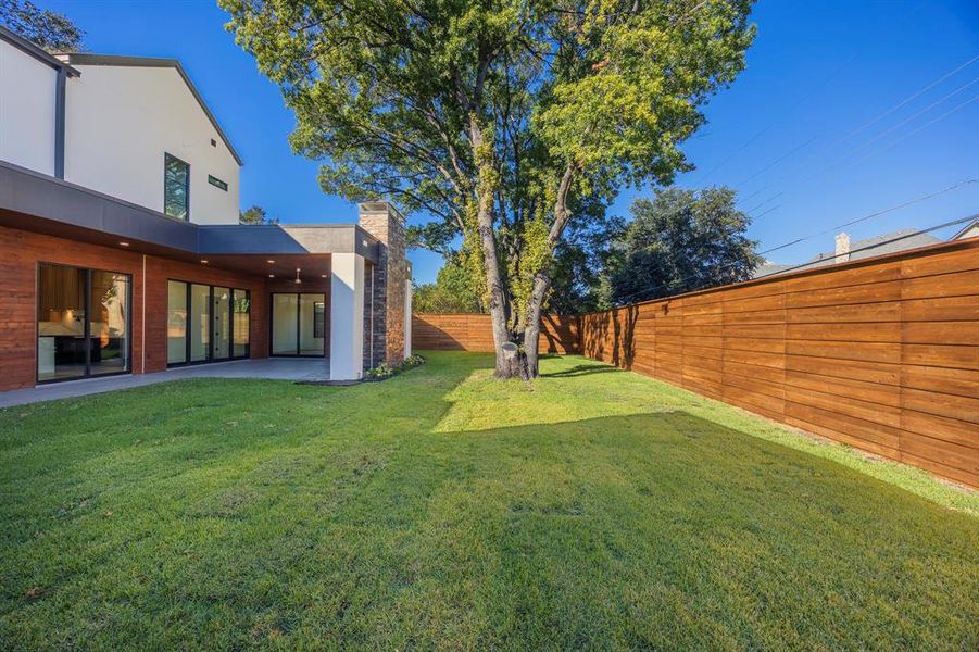 Fenced backyard with a patio area Fenced backyard with a patio area