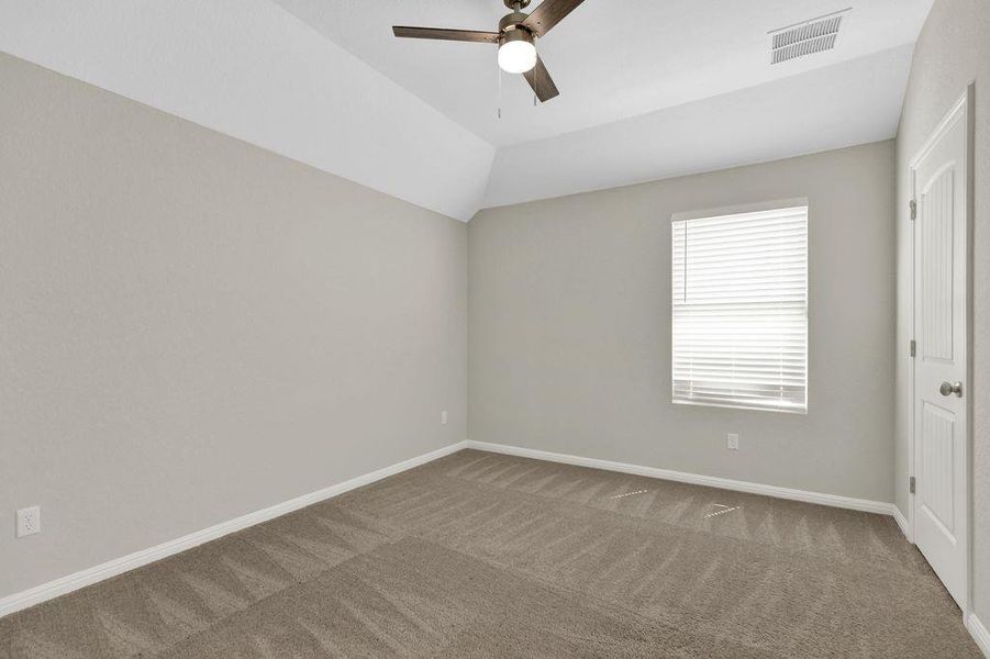 Unfurnished bedroom featuring carpet flooring, ceiling fan, and vaulted ceiling Unfurnished bedroom featuring carpet flooring, ceiling fan, and vaulted ceiling