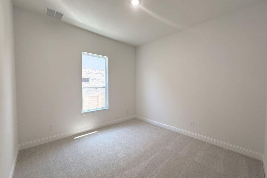 Room featuring neutral-toned walls, recessed lighting, a single window, white trim, and light grey carpeted flooring