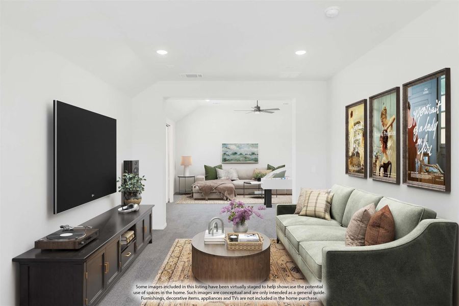 Living room with wall-mounted TV, green sofa, dark media console, and open view into second sitting area with ceiling fan Living room with wall-mounted TV, green sofa, dark media console, and open view into second sitting area with ceiling fan