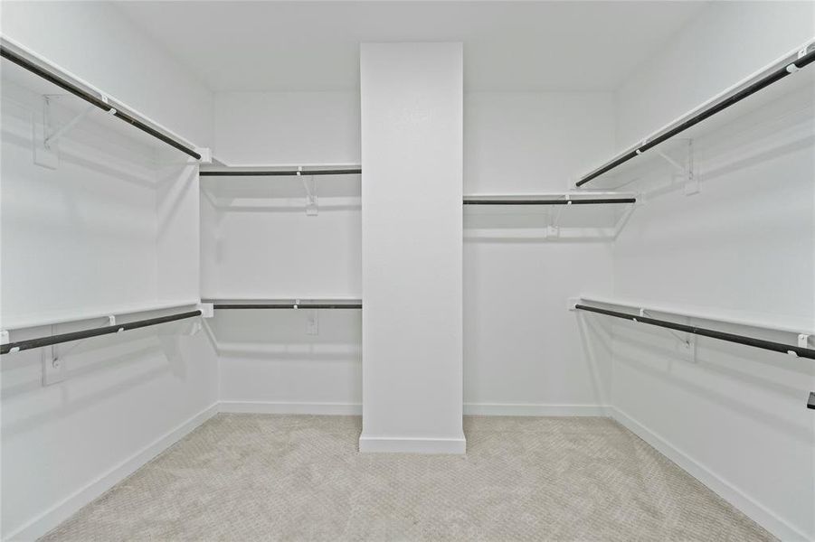 Walk in closet with light colored carpet Walk in closet with light colored carpet
