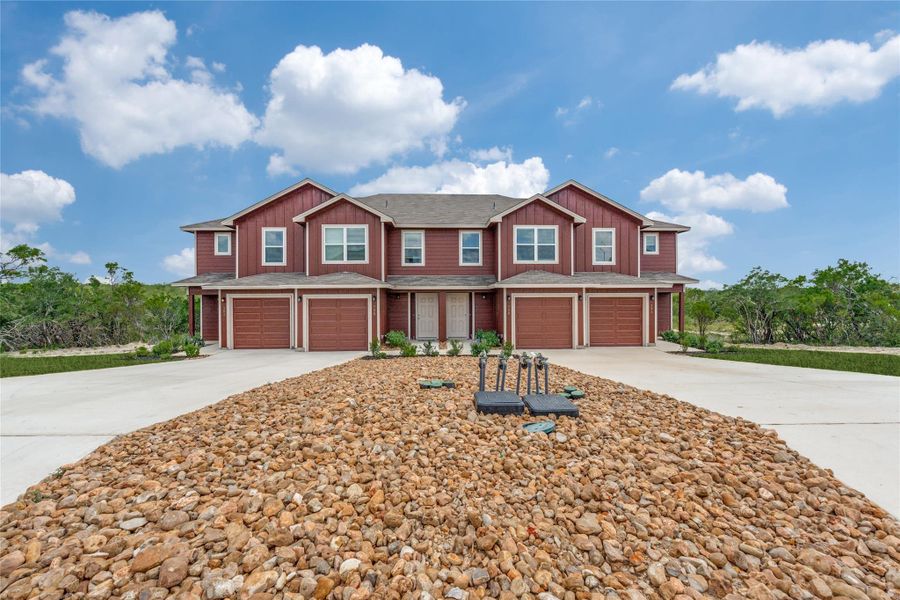 Craftsman house featuring an attached garage, concrete driveway, and board and batten siding Craftsman house featuring an attached garage, concrete driveway, and board and batten siding