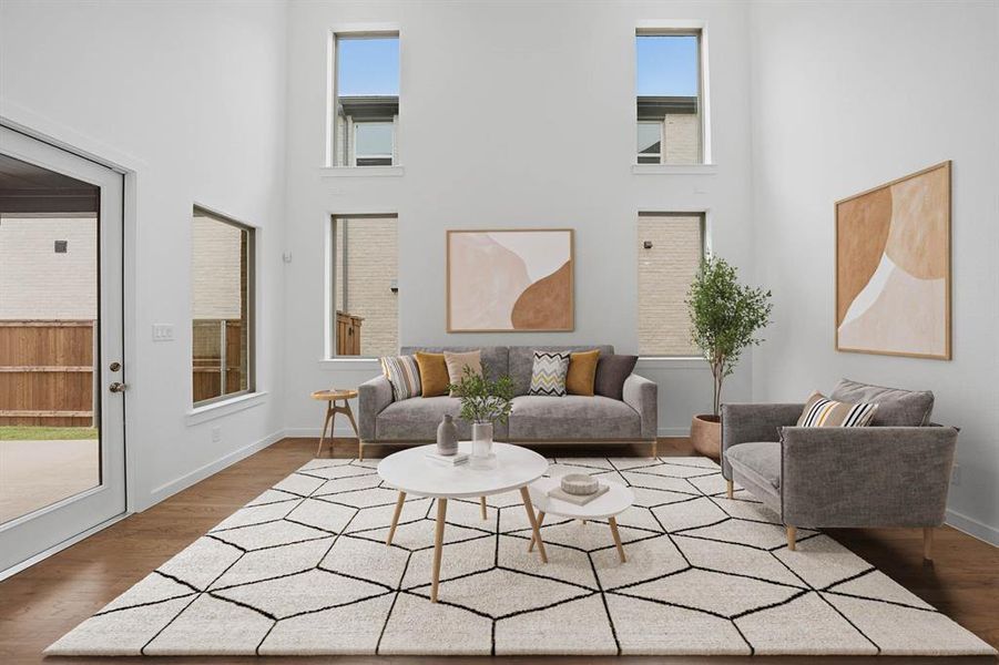 Living room featuring a high ceiling and wood finished floors