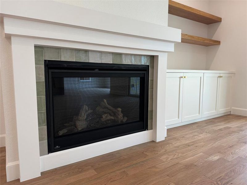 Room details featuring a fireplace and hardwood / wood-style flooring