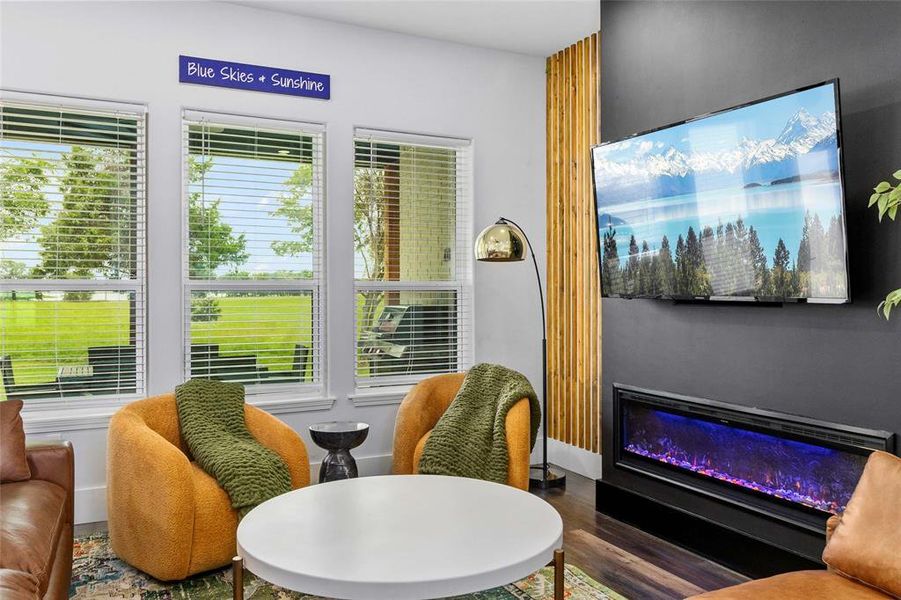 Wall of windows from living room to dining room overlooking back patio and the lake