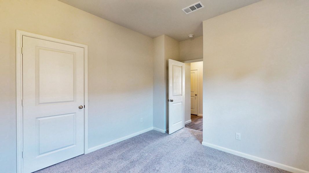 A hallway with white doors. A hallway with white doors.