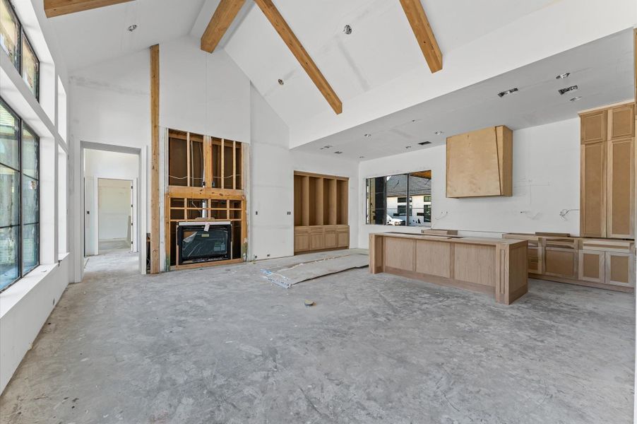 Open concept living area has abundant natural light and cathedral ceilings.