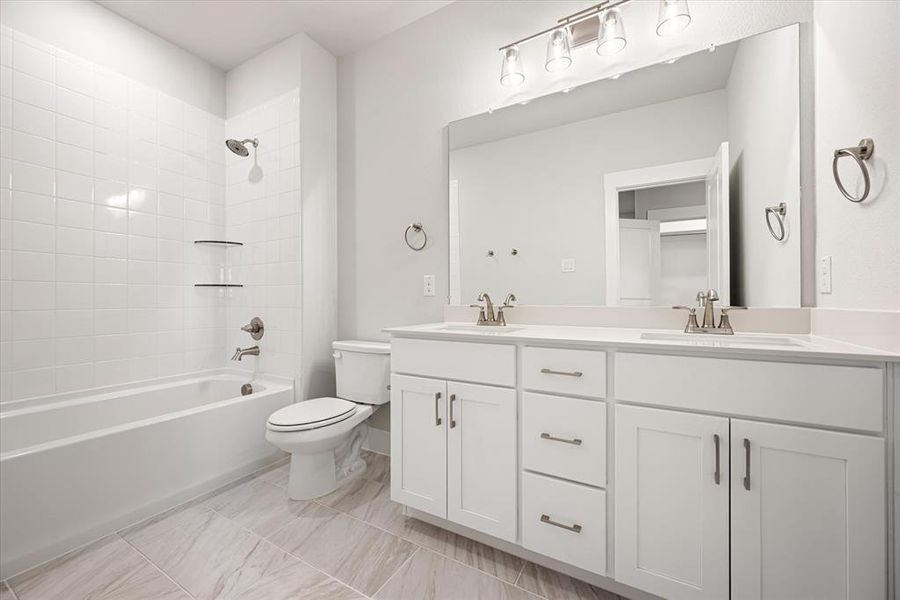 With dual sinks, guests will enjoy their own space in this relaxing guest bath.