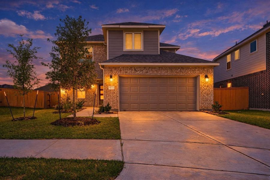 Front exterior of a new home in Sunterra, Katy, TX, highlighting curb appeal (Image 27).