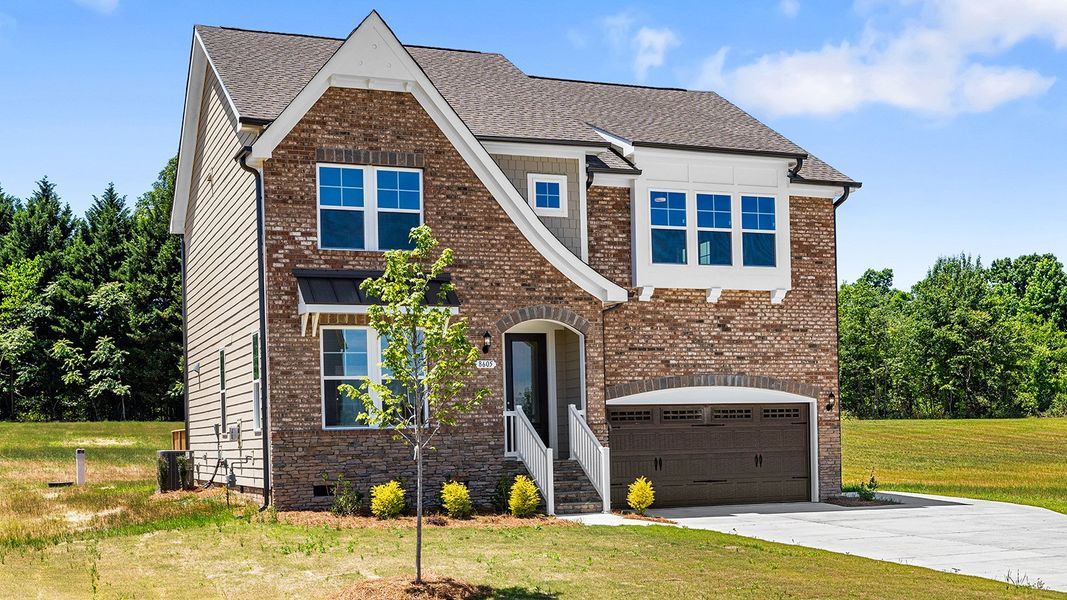 Front exterior of a new home in Lilah Grove, Summerfield, NC, highlighting curb appeal (Image 21).