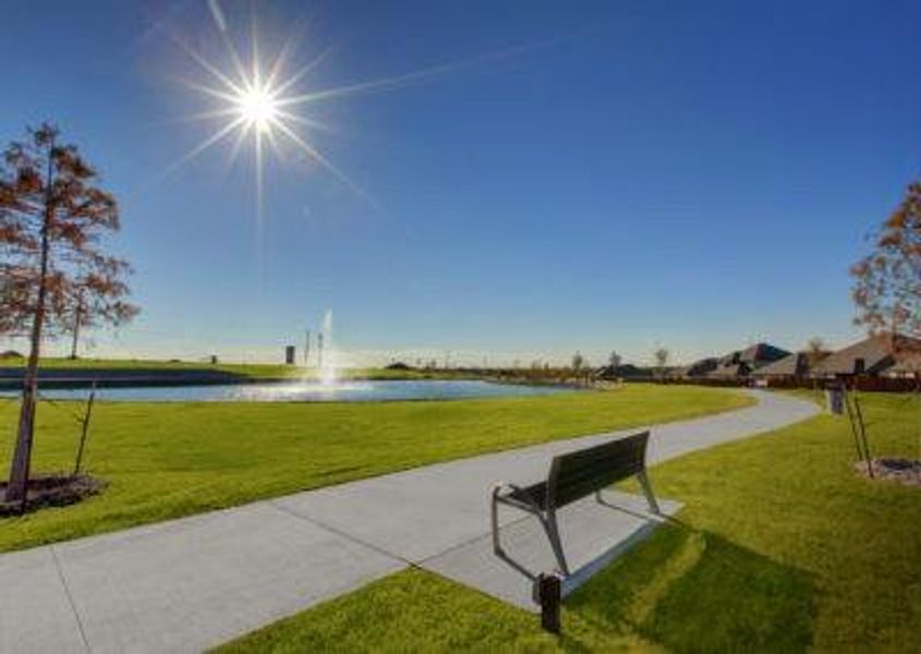 Surrounding community featuring a water view and a lawn