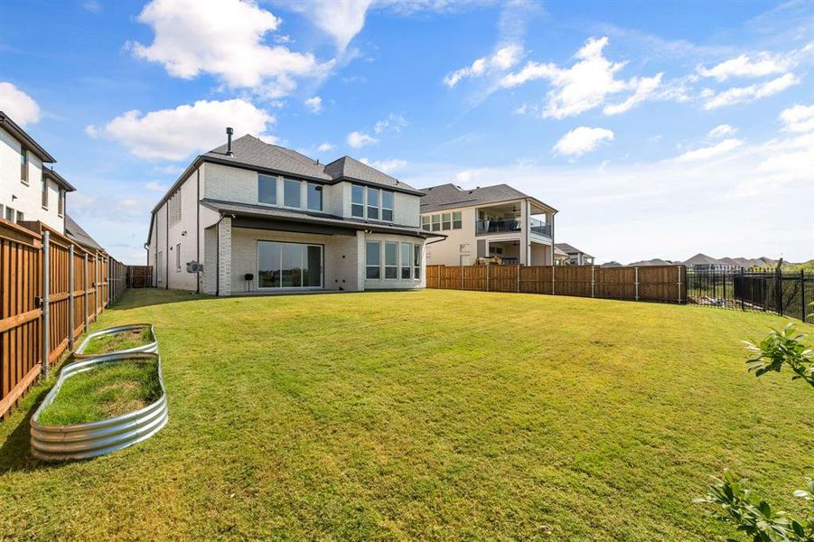 Rear view of house featuring a fenced backyard, brick siding, a patio area, and a residential view Rear view of house featuring a fenced backyard, brick siding, a patio area, and a residential view