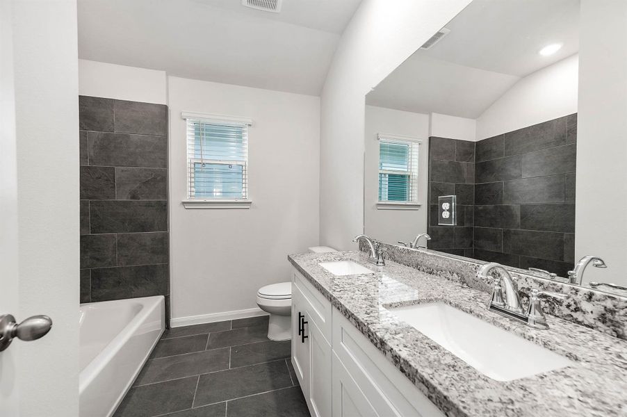 Secondary bathroom complete with a tub/shower combo. Secondary bathroom complete with a tub/shower combo.