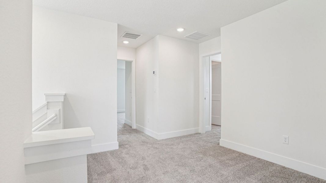 Bright secondary bedroom with carpet in the Plumeria plan at Lakeside at Satilla by DRB Homes. Bright secondary bedroom with carpet in the Plumeria plan at Lakeside at Satilla by DRB Homes.