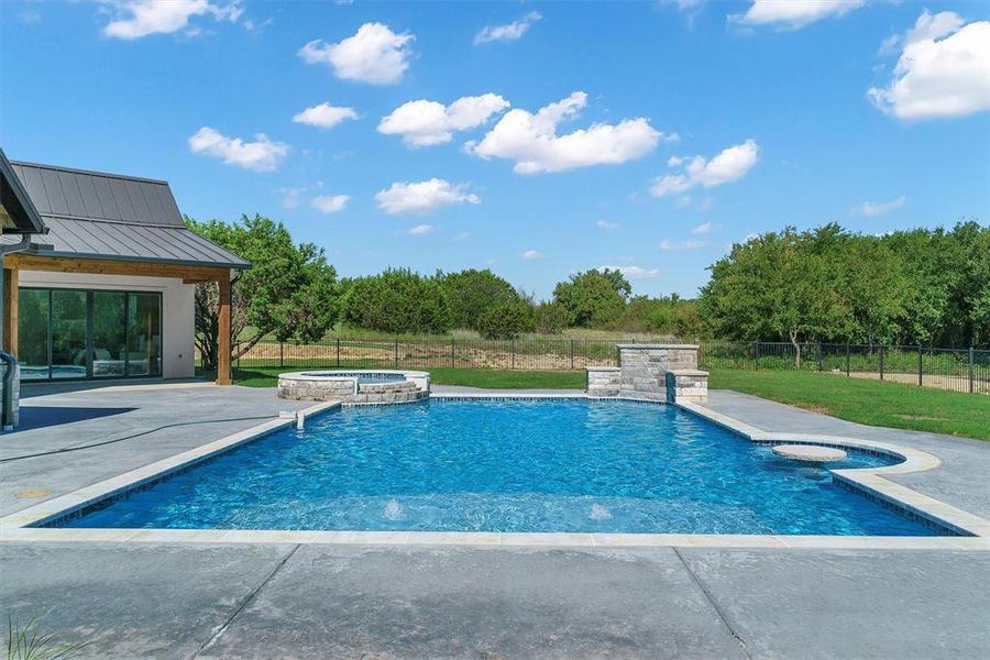 View of pool featuring a patio and an in ground hot tub