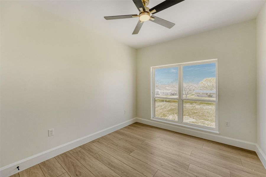 The middle secondary bedroom offers double windows with peaceful views.