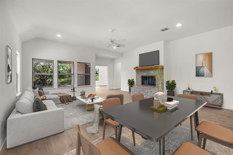 Virtually staged living room with light finished floors, recessed lighting, a fireplace, ceiling fan, and lofted ceiling