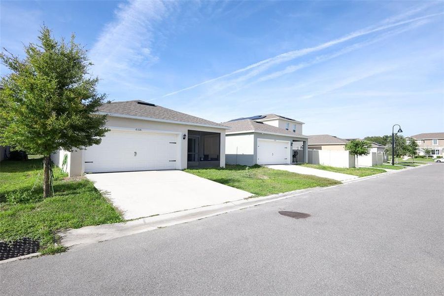 Front exterior of a new home in Windrose, Apopka, FL, highlighting curb appeal (Image 21).