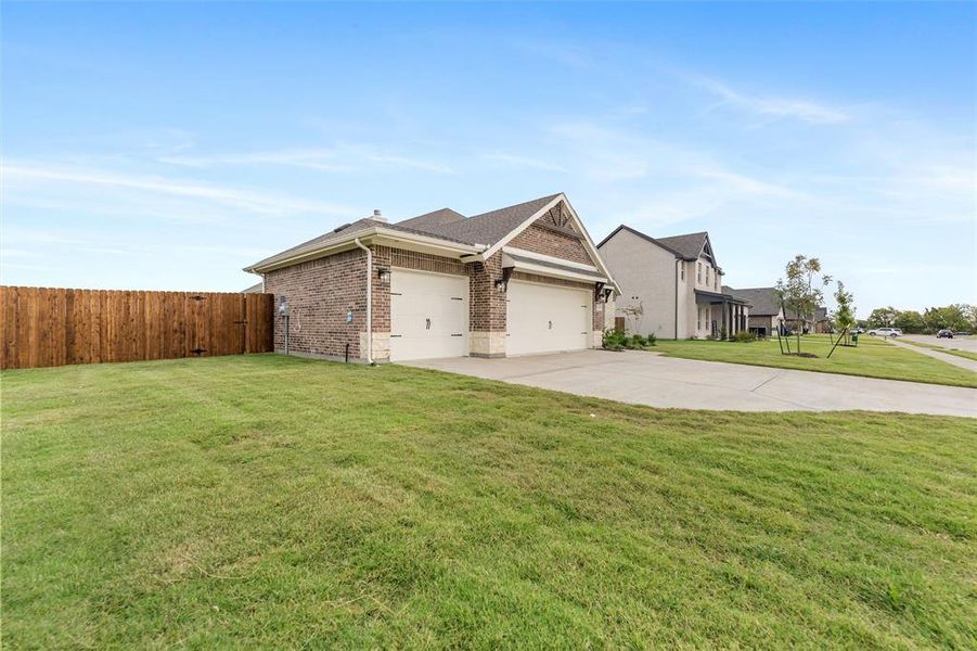 View of side of property featuring concrete driveway, brick siding, a garage, and roof with shingles View of side of property featuring concrete driveway, brick siding, a garage, and roof with shingles