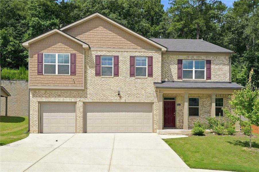 Front exterior of a new home in The Enclave at Flat Rock Hills, Stonecrest, GA, highlighting curb appeal (Image 2). Front exterior of a new home in The Enclave at Flat Rock Hills, Stonecrest, GA, highlighting curb appeal (Image 2).