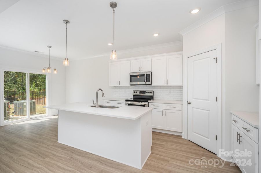 Representative Photo. Quartz & white dovetail soft-close shaker cabinetry