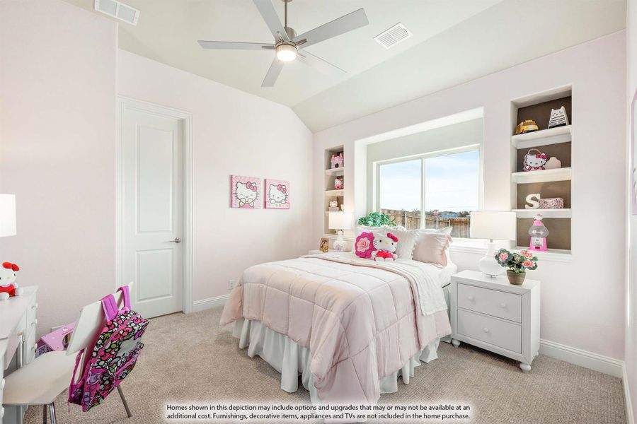 Girl's bedroom with pink bedding, vaulted ceiling, ceiling fan, and built-in shelves flanking a window