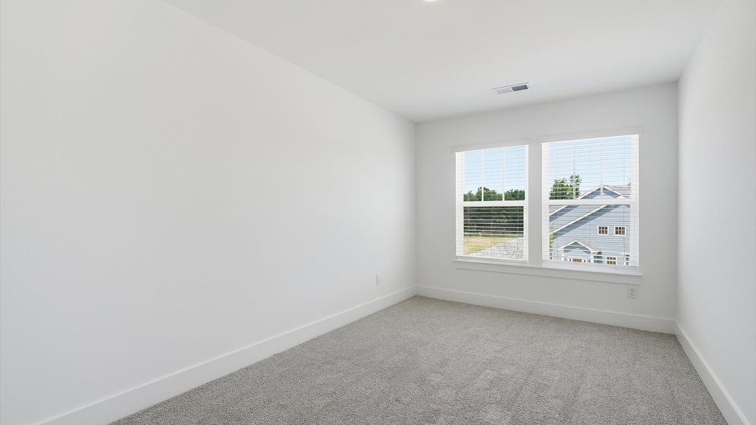 Elegant bedroom retreat featuring soft carpet and oversized windows that create a bright, welcoming space at Barton Hollow Elegant bedroom retreat featuring soft carpet and oversized windows that create a bright, welcoming space at Barton Hollow