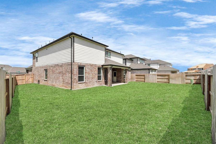 Experience outdoor living at its finest on this expansive covered patio, thoughtfully designed for BBQs and delightful al fresco dining.