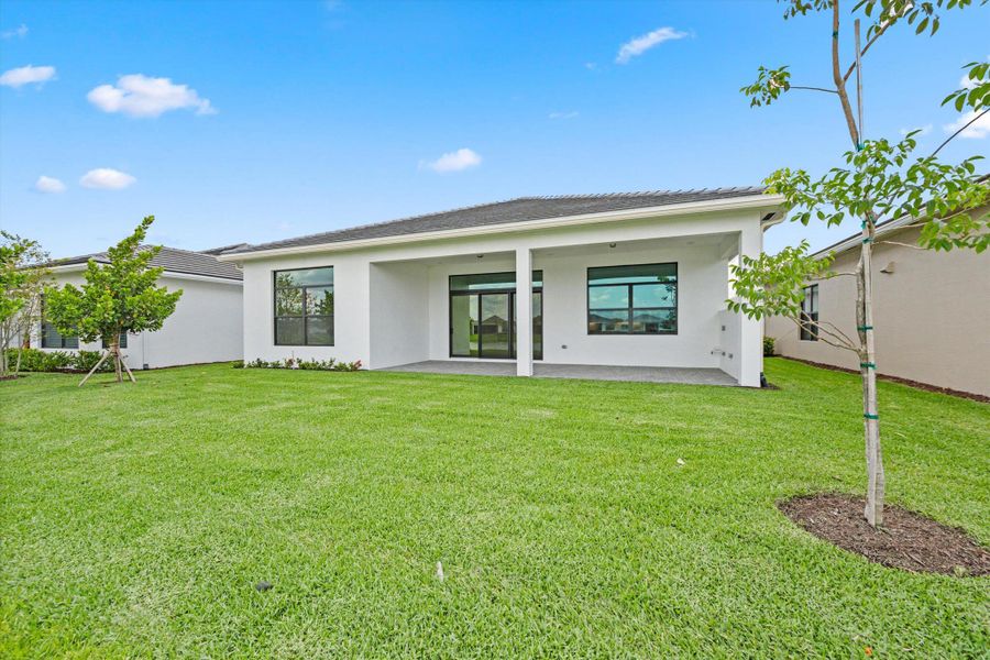 Front exterior of a new home in Cresswind Palm Beach at Westlake, Westlake, FL, highlighting curb appeal (Image 2). Front exterior of a new home in Cresswind Palm Beach at Westlake, Westlake, FL, highlighting curb appeal (Image 2).