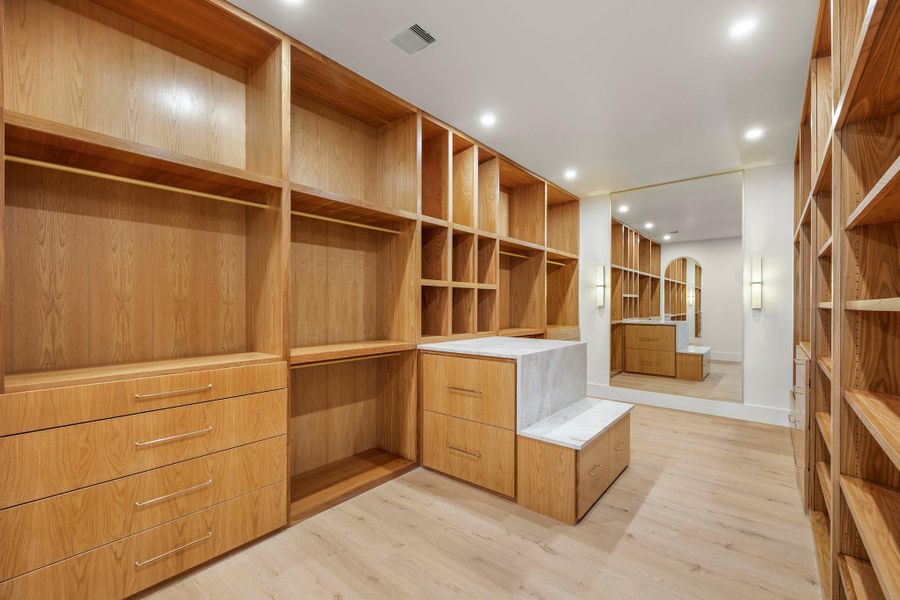 View of primary closet (HERS). View of primary closet (HERS).